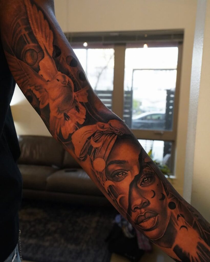 Tattoo sleeve featuring a portrait of a Black woman and a bird.