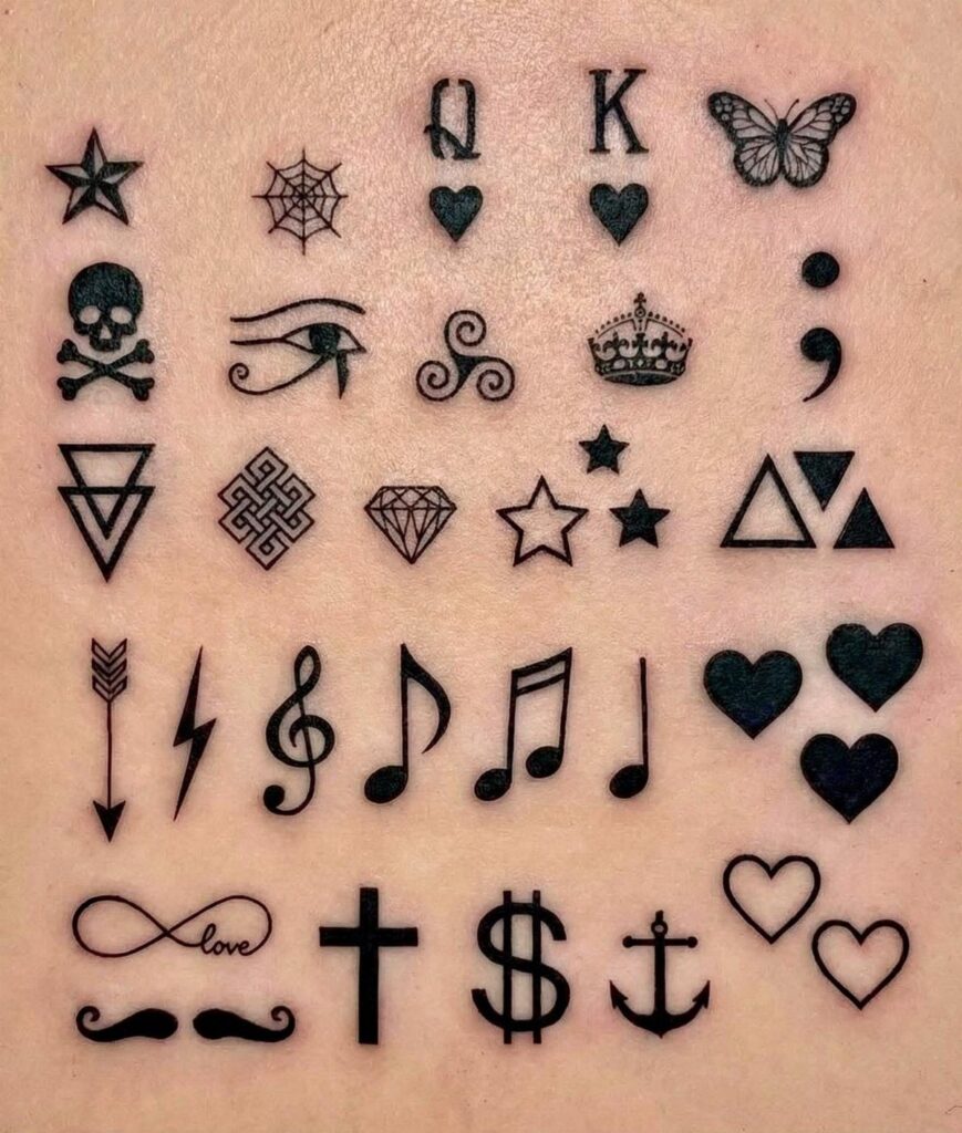 Various small black ink tattoo designs arranged on a person's skin.