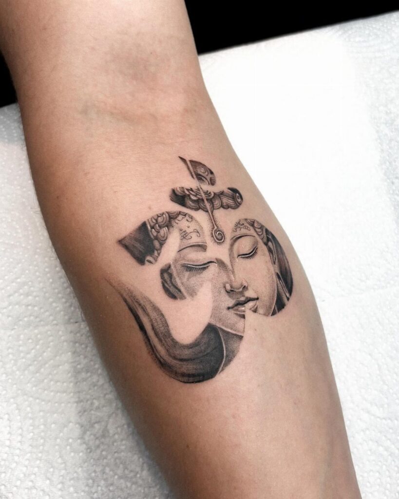 Om symbol tattoo blending faces of Shiva and Parvati on a forearm