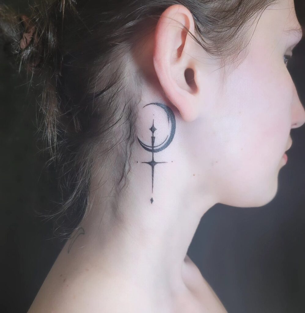 Crescent moon and celestial star tattoo on the side of a person's neck.